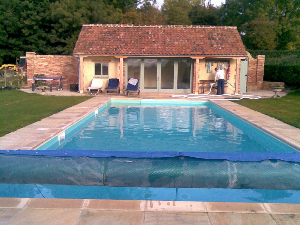 Maintenance on outdoor pool with pool house