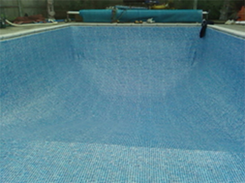 Empty outdoor pool with reel system and cover