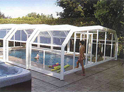 Outdoor swimming pool with glass cover on tiles