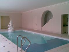 Indoor swimming pool with specialised cover covering half of the pool 3